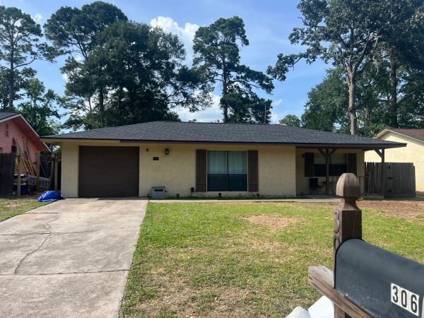 Single-story house with garage and mailbox.