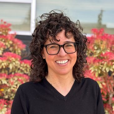 Picture of Ash Goddard DACM, LAc, in front of flowers