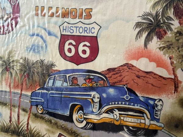 Illustration of a vintage blue car on Illinois Historic Route 66 with palm trees and mountains.
