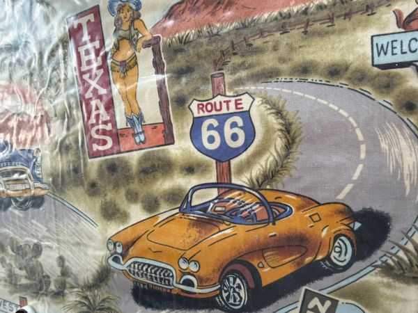 Vintage Route 66 scene with an orange classic car and Texas pin-up girl.