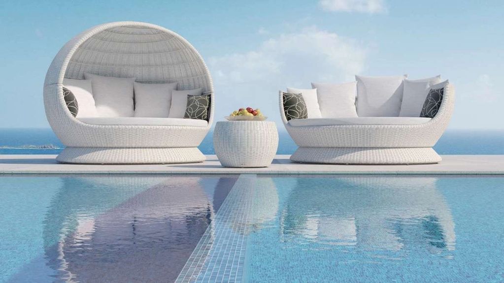 Tidal collection — A canopy daybed, curved seating and a woven occasional table. Sculptural white fo