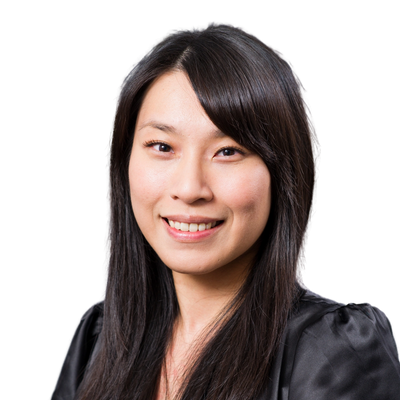 Smiling woman with long black hair in a black blouse.