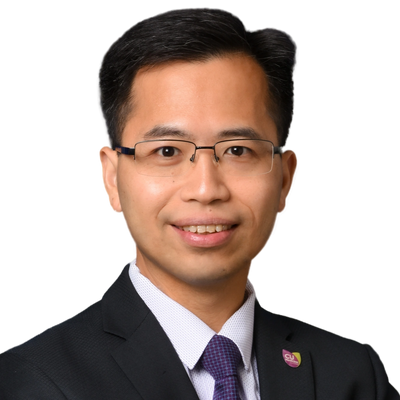 Professional man in suit and tie with glasses smiling.