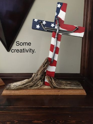Creative cross art with American flag paint and bent nails.