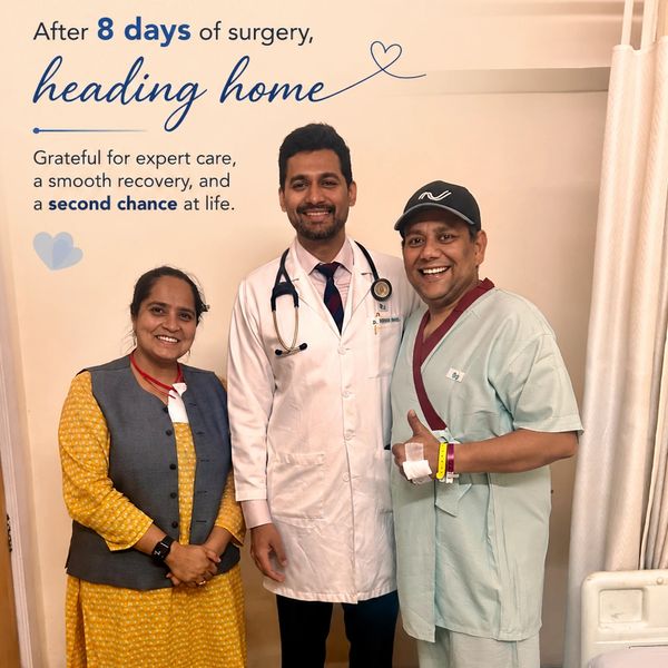 Patient, doctor, and companion smiling after successful surgery and recovery.