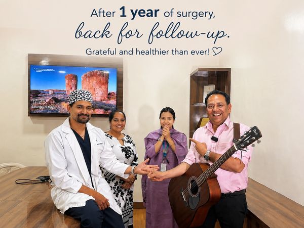 A joyful patient with a guitar celebrates one year post-surgery with medical staff.