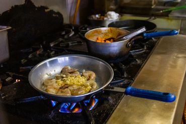 Two Pans With Food being Heated