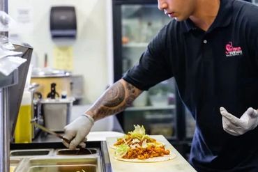 A Man Working On Food on A Plate