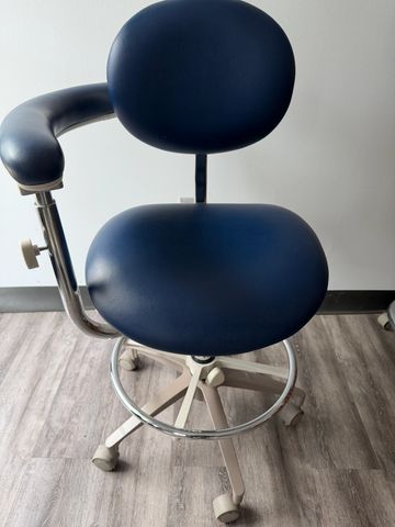 Modern ergonomic office chair with blue cushions and wheels.