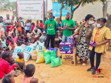 Community donation event with people receiving supplies.