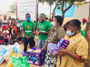 Volunteers distributing supplies to a community.