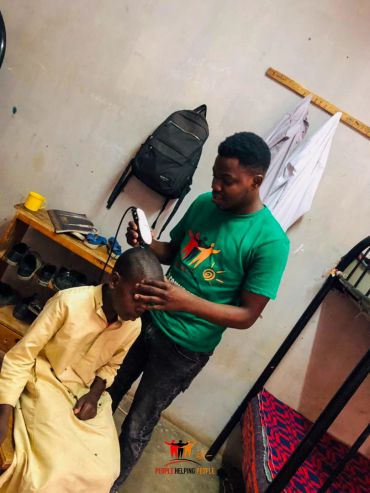 Man giving a haircut indoors.