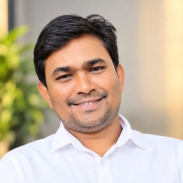 Smiling man in a white shirt.
