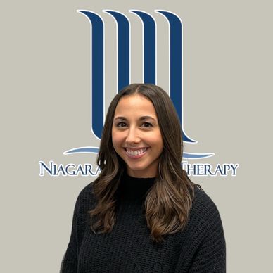 Smiling woman in black sweater with Niagara Therapy logo background.