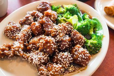 Sesame chicken with broccoli served on a plate at Shanghai Express Chinese restaurant.