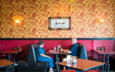 a couple sitting in a restaurant booth