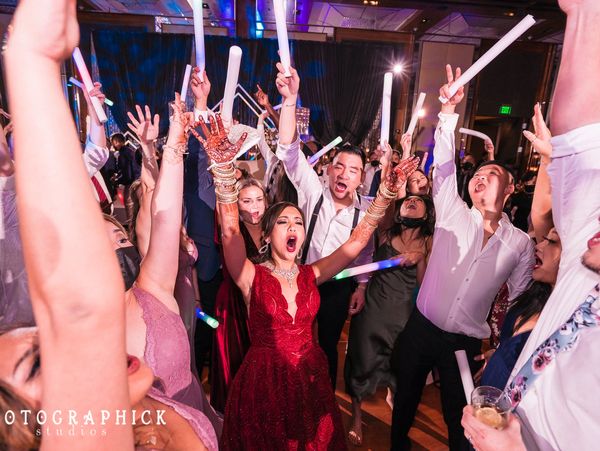 DJ Sal Flip has the crowds arms up at a wedding in Baltimore Maryland at the Four Seasons Hotel.
