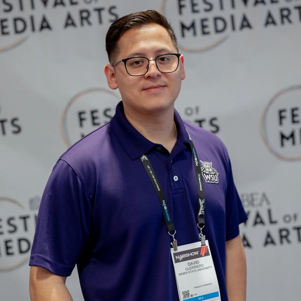 A man in a purple WSU polo shirt at the Festival of Media Arts event.