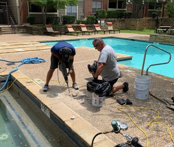 Workers repairing a swimming pool