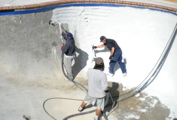 Workers replastering pool