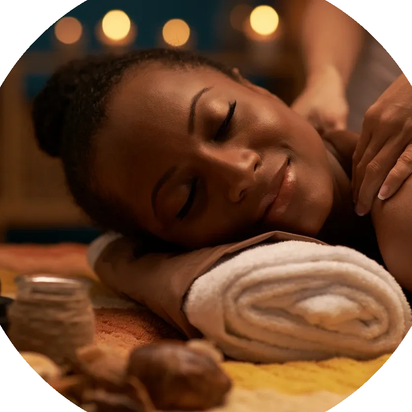 Woman getting a shoulder massage while smiling.