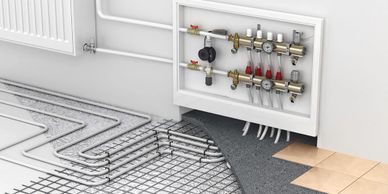 Underfloor heating system with manifold and pipework setup.