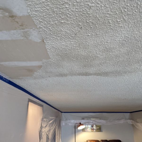 Scraping down popcorn ceiling to put up knockdown texture.