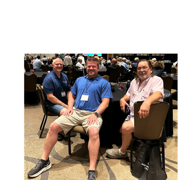3 campground operators sit facing camera at a conference. 