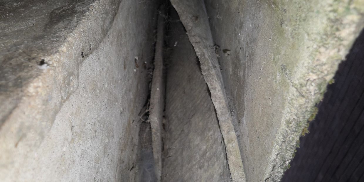 A photo of asbestos cement roof with lays of further asbestos cement.