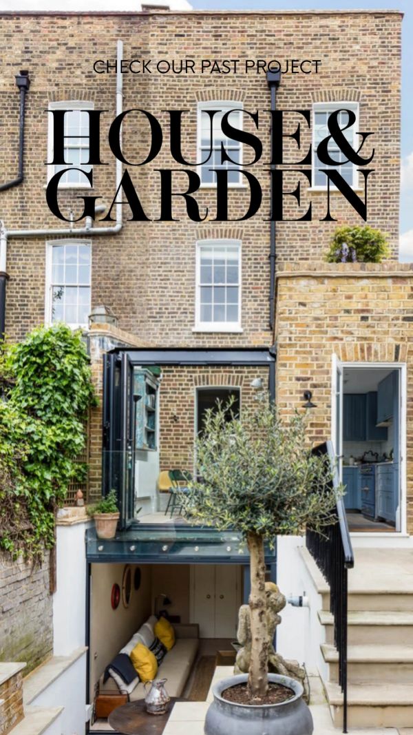 Modern house and garden with cozy lower-level seating and greenery.