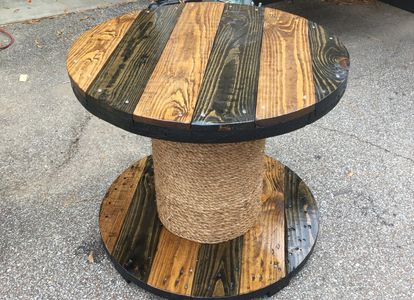 This is accustom table built and refinished after being banded in rope
