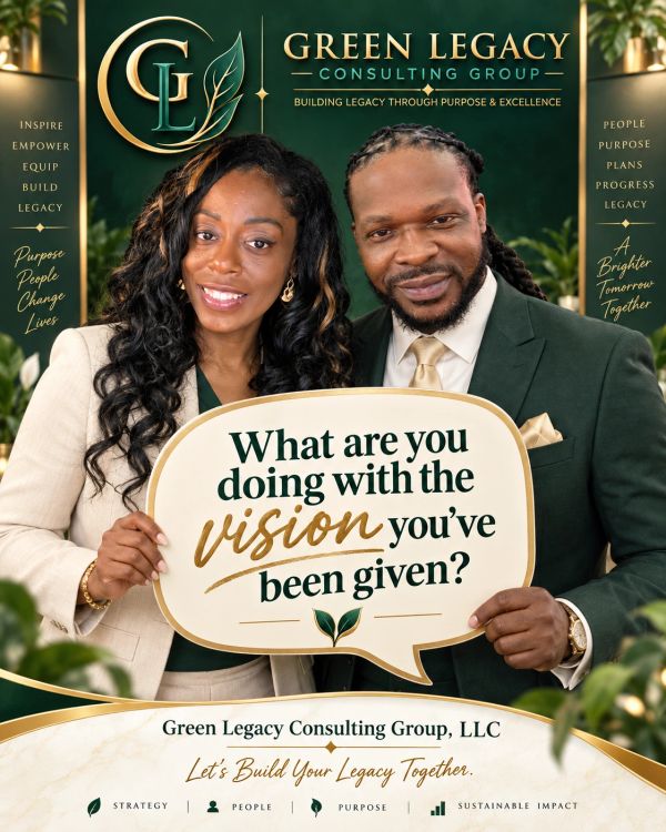 Two professionals hold a sign about vision and legacy.