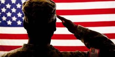 Silhouette of a soldier saluting the American flag.