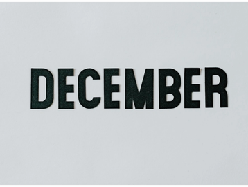 The word DECEMBER in bold black letters on a white background.