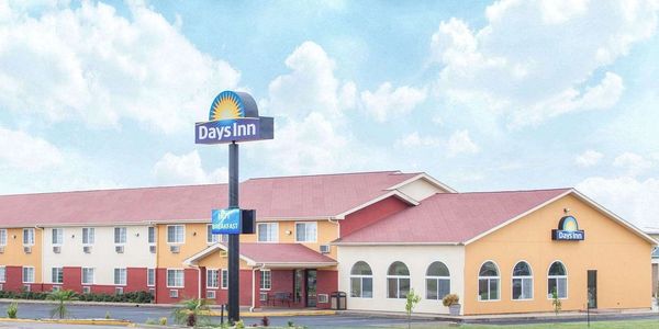 Exterior of a Days Inn hotel with clear skies.