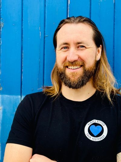 Ryan Hartley smiling against a blue background