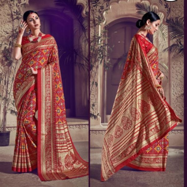 Elegant woman modeling a traditional red and gold saree with intricate patterns.