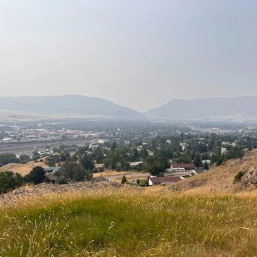 View of a small town with hills in the background.