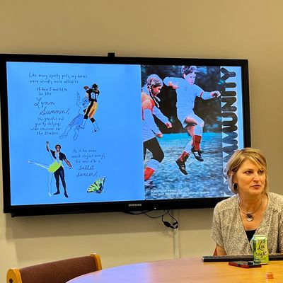 Woman presenting sports and arts images on a screen during a meeting.