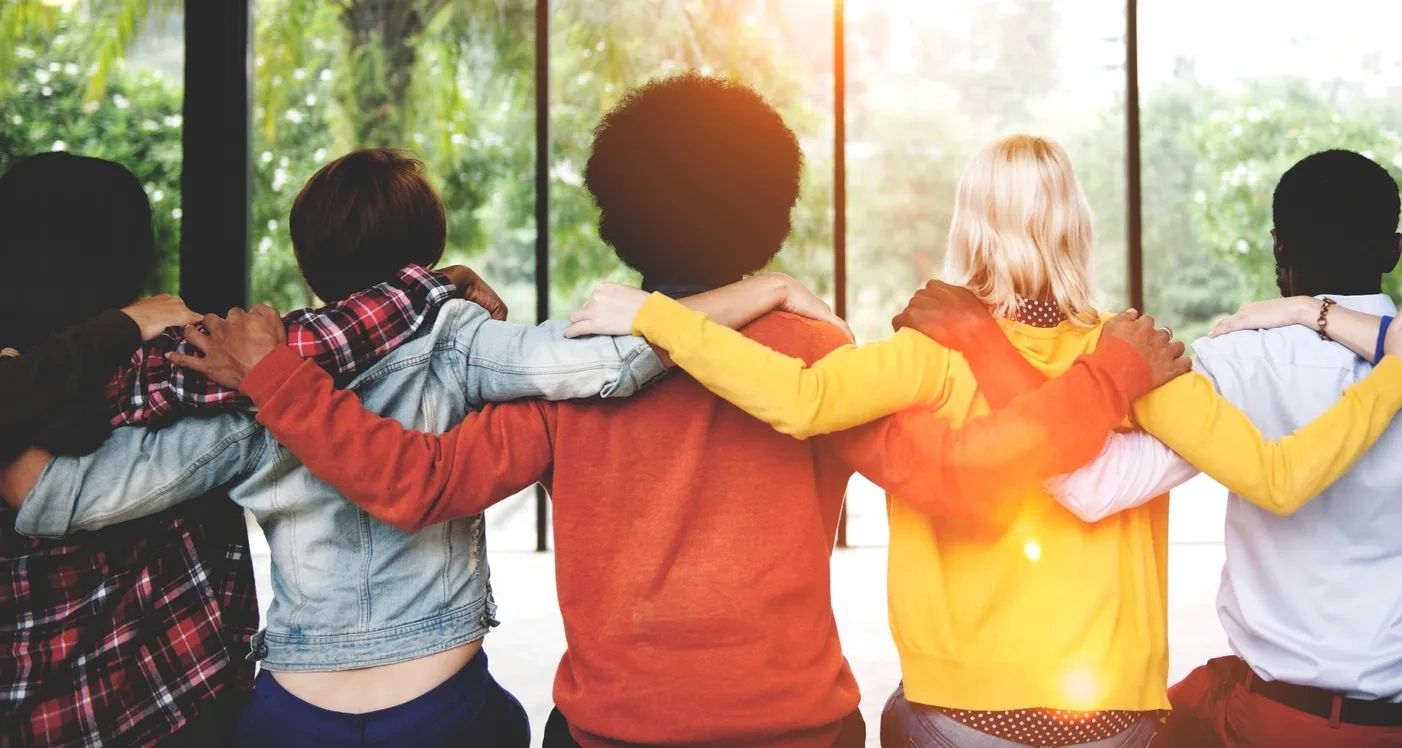 A group of people hugging each other as symbol of support. 