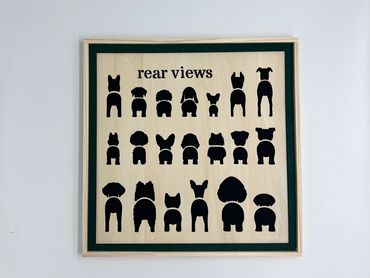 Wooden framed art showing rear silhouettes of various dog breeds.