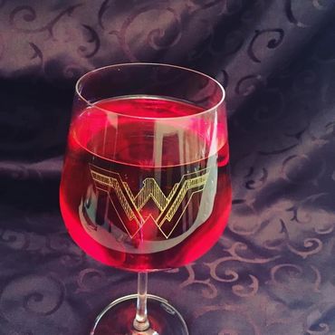 Breast Cancer Fundraiser
Red wine glass with Wonder Woman design with gold leaf color fill