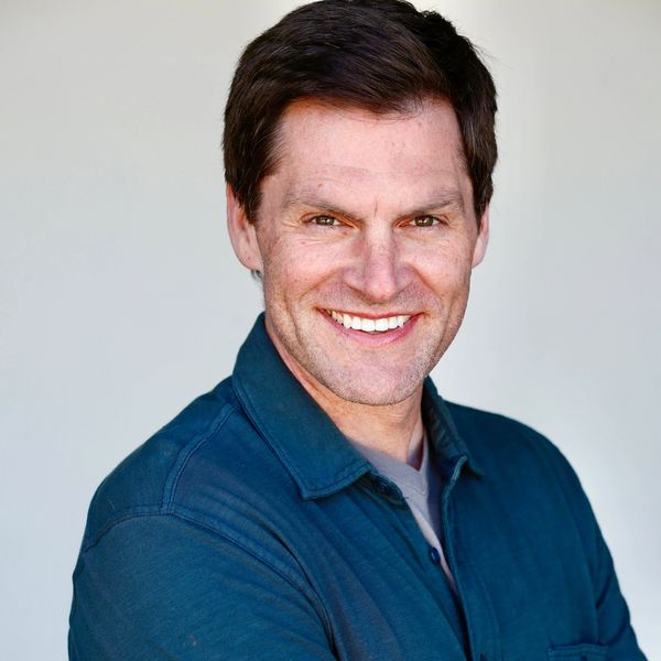 Smiling man in a blue shirt.