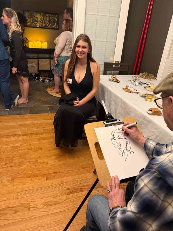 Woman in a black dress posing for a caricature artist.