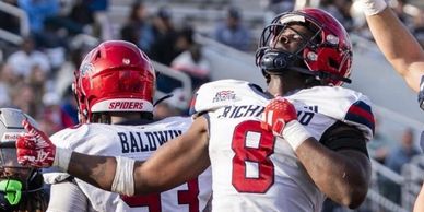 Richmond Spiders football player celebrating with intensity on the field.