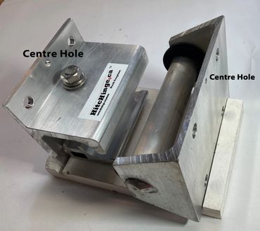 Metal bracket with a center hole and a bolt on a white surface.