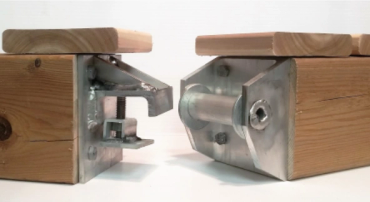 Close-up of metal connectors attached to wooden beams for structural joining.
