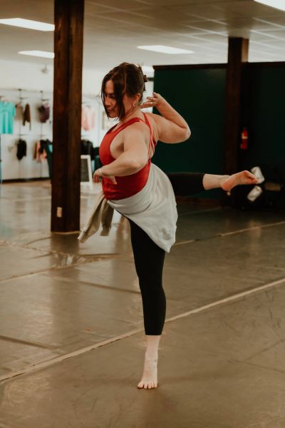 Woman balancing in a dance studio.