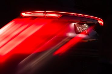 Car's rear lights glowing with motion blur.