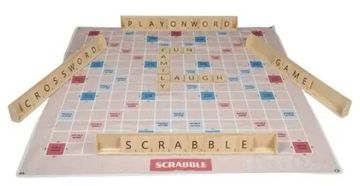 Scrabble game board with words and tile racks arranged for play.
